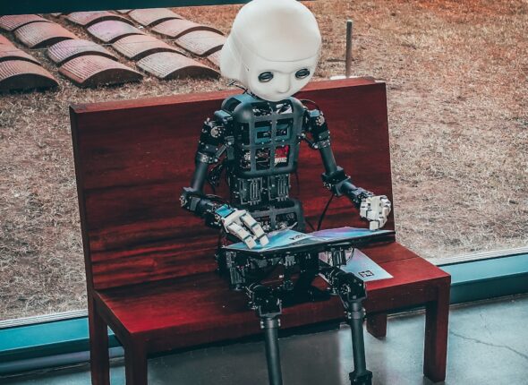 black and white robot toy on red wooden table