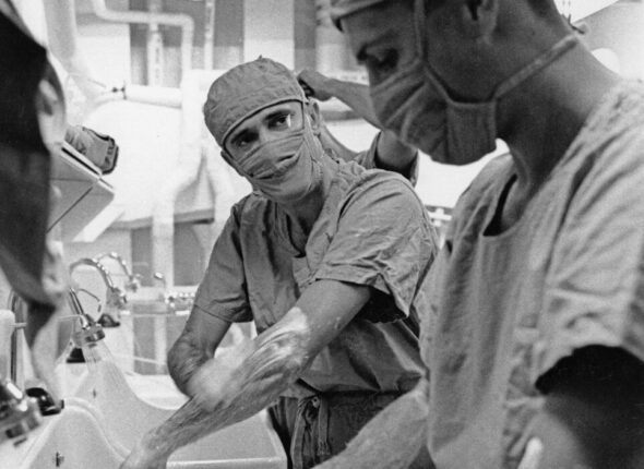 Surgeons scrubbing hands before operation in sterile environment