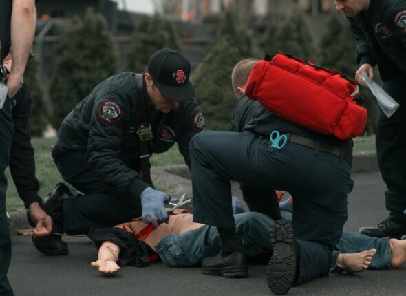 a group of people with a person on the ground